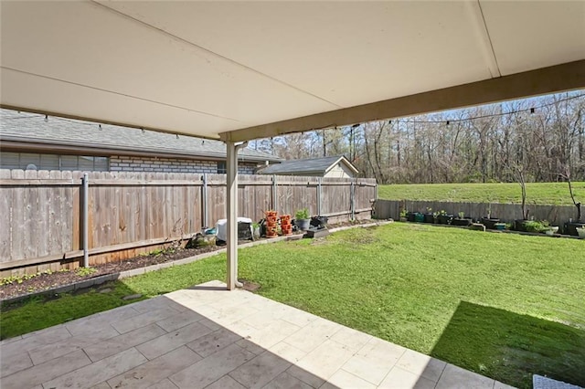 view of yard with a patio area and a fenced backyard