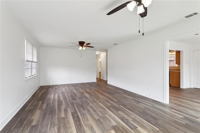 unfurnished living room featuring ornamental molding, wood finished floors, visible vents, and baseboards