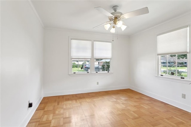 unfurnished room with baseboards, ornamental molding, and a ceiling fan