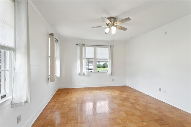 spare room with crown molding, baseboards, and ceiling fan