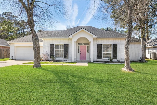 single story home featuring a garage, driveway, a front yard, and brick siding