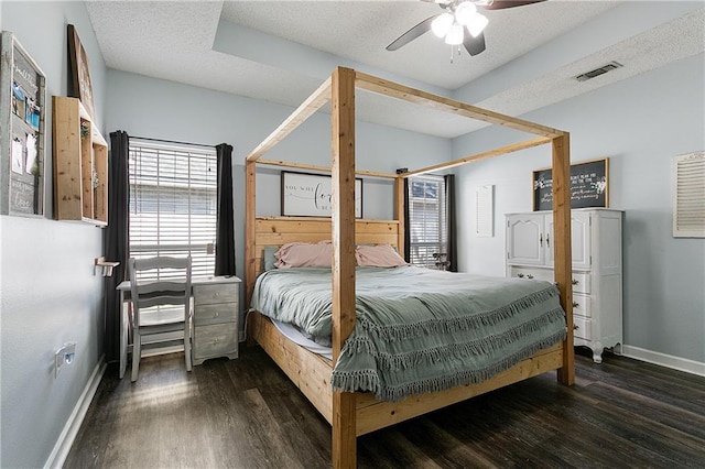 bedroom featuring a textured ceiling, visible vents, and wood finished floors