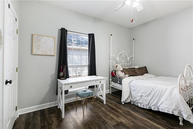 bedroom featuring ceiling fan, baseboards, and wood finished floors