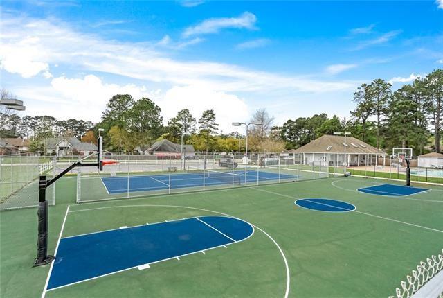 view of sport court with a tennis court, community basketball court, and fence