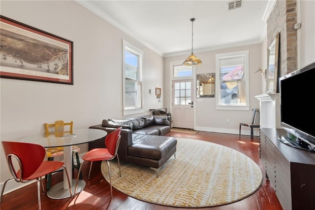 living room featuring ornamental molding, wood finished floors, and visible vents