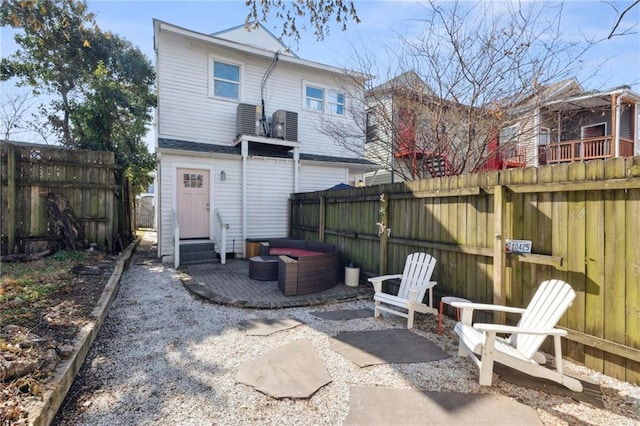 back of property featuring entry steps, a patio, and a fenced backyard