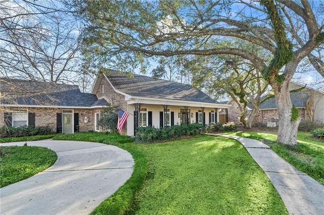 view of front of home with a front yard, driveway, and stucco siding