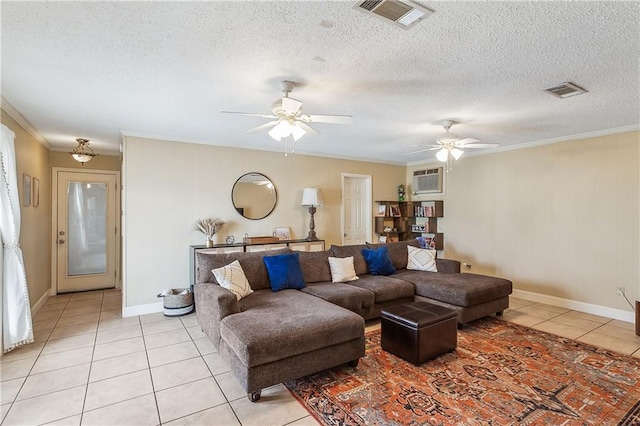 living area with a textured ceiling, ceiling fan, light tile patterned flooring, visible vents, and crown molding