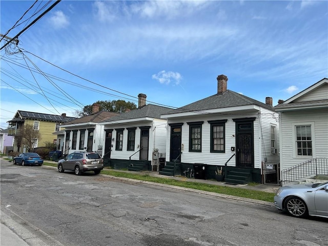 view of front of property featuring entry steps and roof with shingles