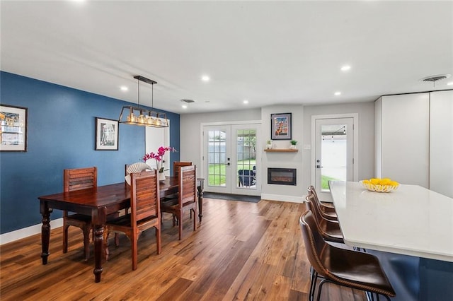 dining room with french doors, recessed lighting, wood finished floors, and baseboards