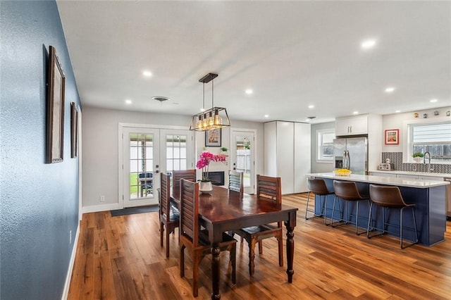 dining space with recessed lighting, french doors, baseboards, and wood finished floors