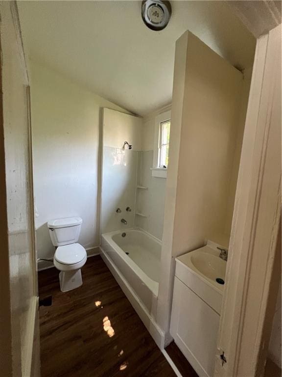 full bathroom featuring shower / bath combination, toilet, wood finished floors, vaulted ceiling, and vanity