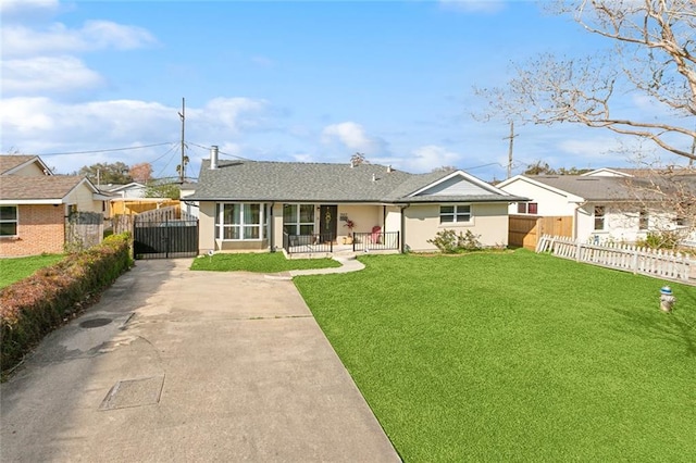 back of house with a gate, stucco siding, a lawn, and fence