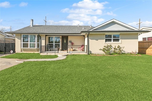 back of house featuring covered porch, fence, a lawn, and stucco siding