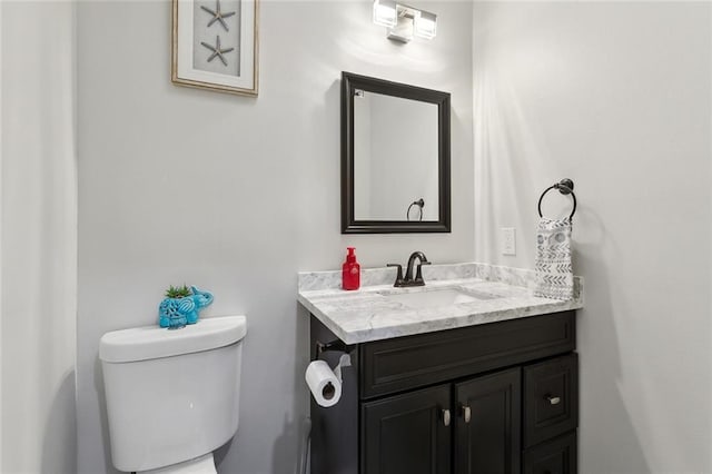 bathroom featuring toilet and vanity