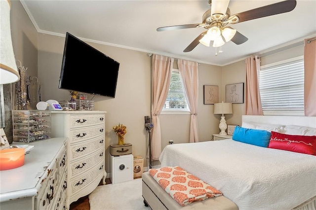 bedroom with ornamental molding and a ceiling fan