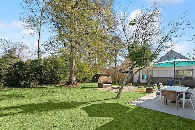 view of yard featuring fence and a patio