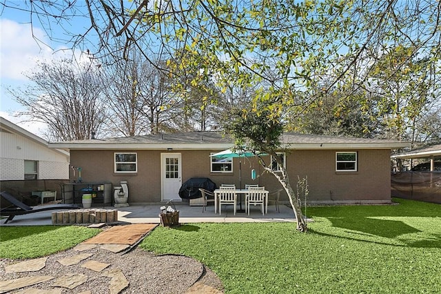 back of property featuring a yard, brick siding, a patio, and fence