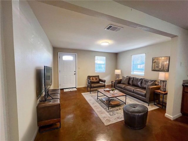 living room with visible vents, finished concrete flooring, and baseboards