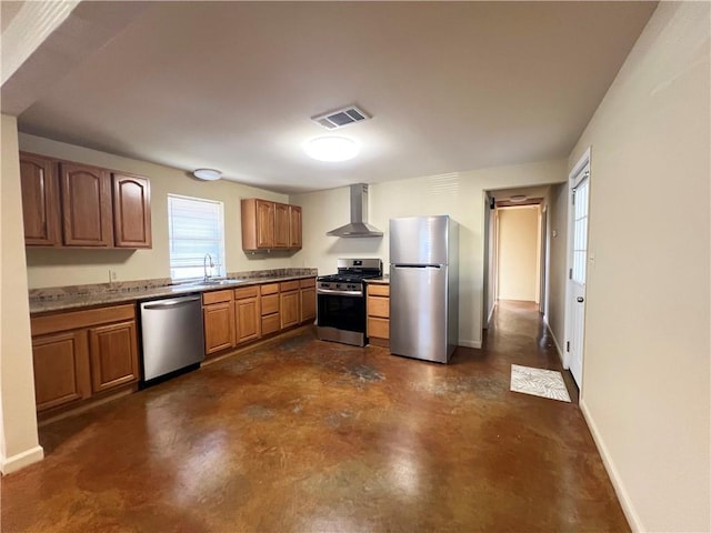 kitchen with concrete floors, a sink, visible vents, appliances with stainless steel finishes, and wall chimney range hood