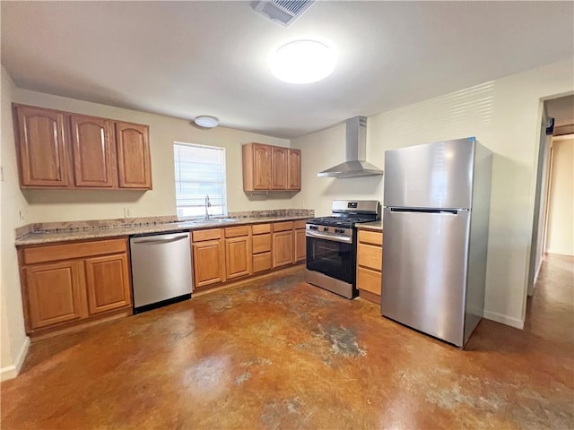 kitchen with concrete flooring, stainless steel appliances, a sink, visible vents, and wall chimney range hood