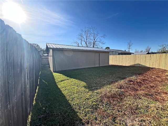 view of yard featuring an outbuilding and a fenced backyard