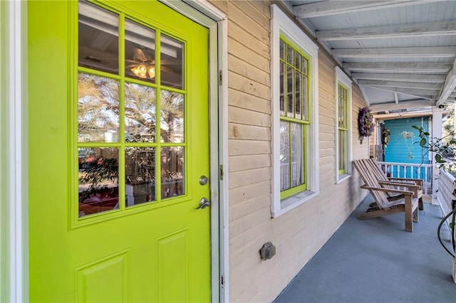 view of exterior entry with covered porch