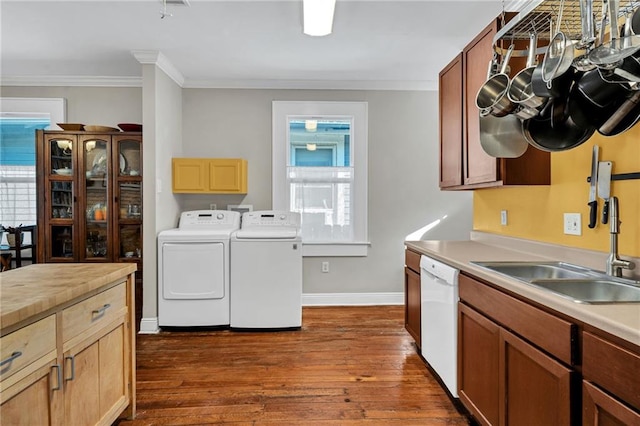 kitchen with plenty of natural light, white dishwasher, independent washer and dryer, and a sink