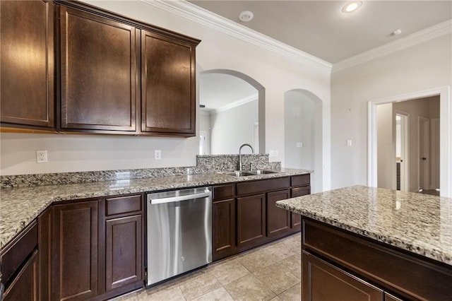 kitchen featuring light stone counters, dark brown cabinetry, dishwasher, and a sink