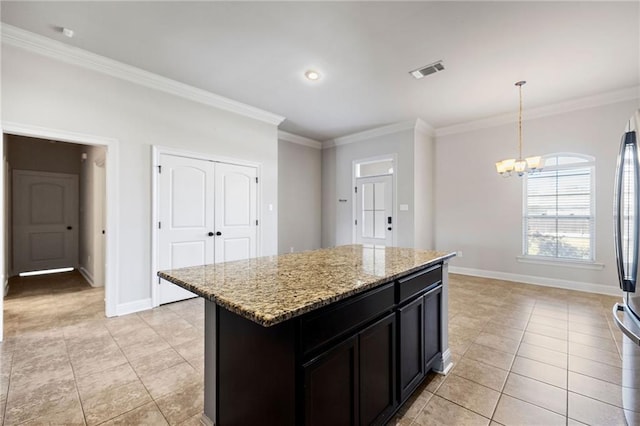 kitchen featuring crown molding, light stone counters, visible vents, and an inviting chandelier