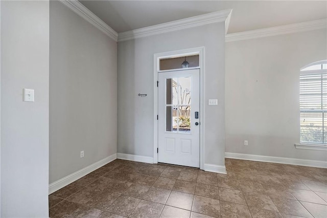 foyer with ornamental molding and baseboards