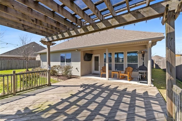 view of patio featuring a fenced backyard, a grill, a pergola, and a wooden deck