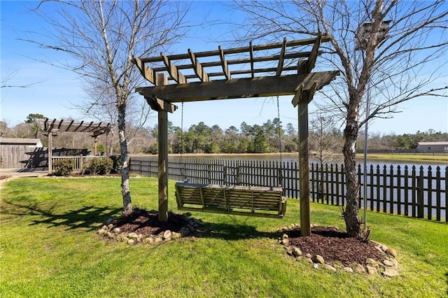 view of yard featuring a water view, fence, and a pergola