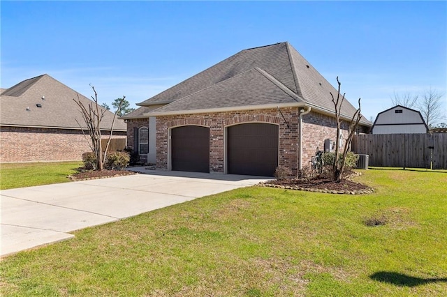 french country inspired facade with brick siding, a front yard, fence, cooling unit, and driveway