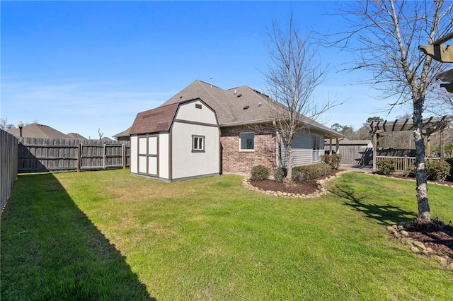 rear view of house featuring a shed, an outdoor structure, a fenced backyard, and brick siding