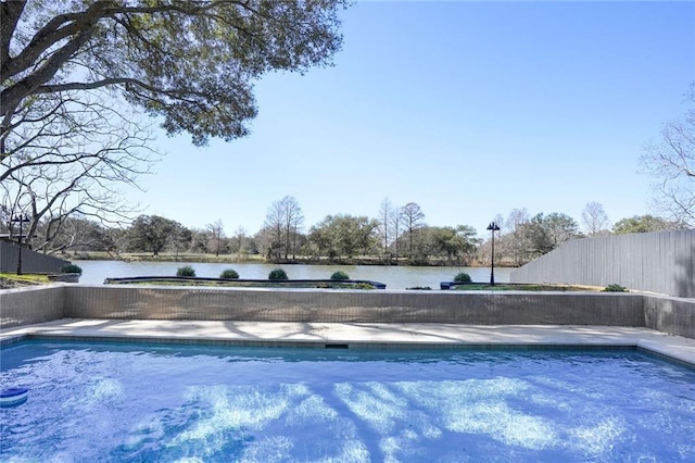 view of pool featuring a fenced in pool, a water view, and fence