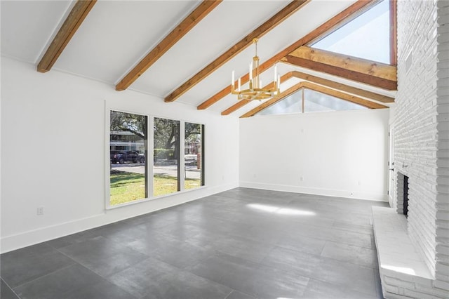 unfurnished living room featuring lofted ceiling with beams, a brick fireplace, an inviting chandelier, and baseboards