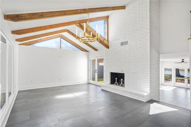 unfurnished living room featuring high vaulted ceiling, french doors, a brick fireplace, and beam ceiling