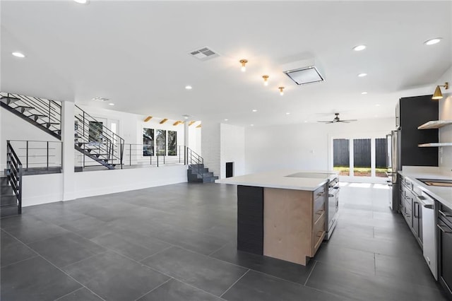 kitchen featuring light countertops, a wealth of natural light, visible vents, and open shelves