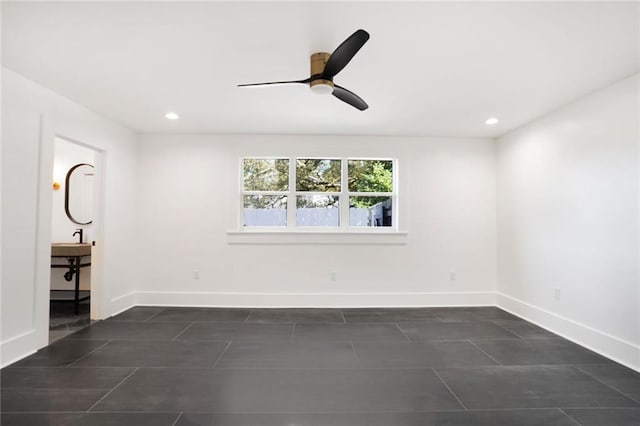 empty room featuring baseboards, ceiling fan, dark tile patterned flooring, and recessed lighting