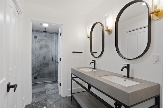 full bath featuring marble finish floor, double vanity, a stall shower, and a sink