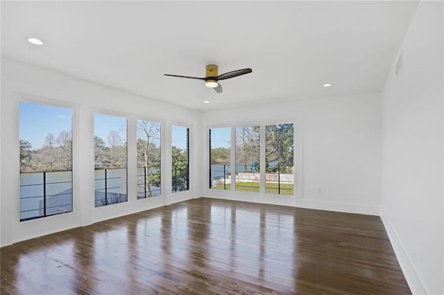 unfurnished room featuring ceiling fan, baseboards, wood finished floors, and recessed lighting