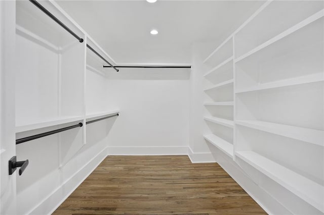 walk in closet with wood finished floors