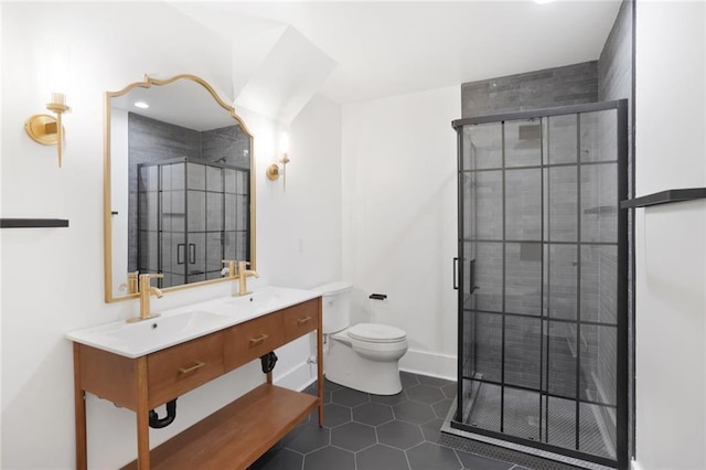 bathroom featuring a stall shower, a sink, toilet, and double vanity