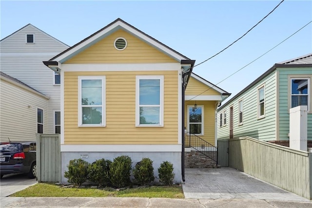 shotgun-style home featuring fence