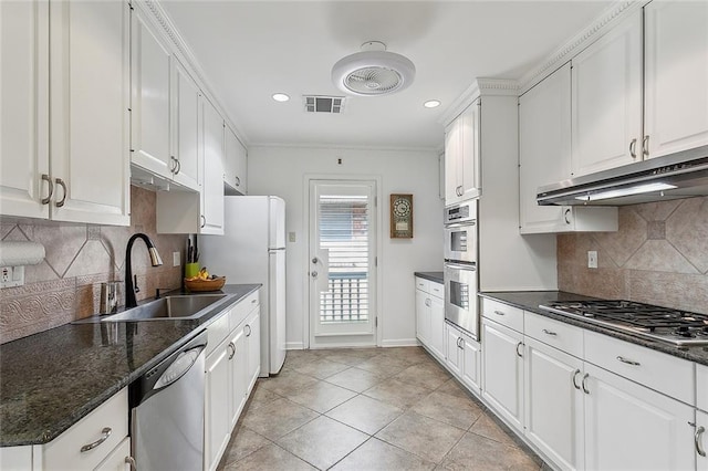 kitchen with visible vents, white cabinets, appliances with stainless steel finishes, under cabinet range hood, and a sink