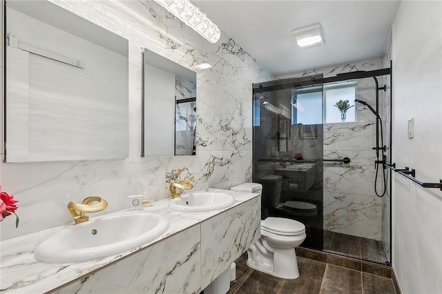 bathroom featuring toilet, a marble finish shower, tile walls, and a sink