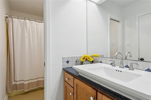 bathroom with a shower with shower curtain, tasteful backsplash, and vanity