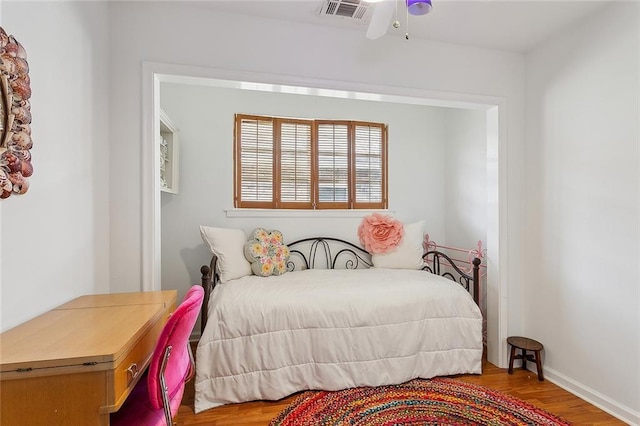 bedroom featuring wood finished floors and visible vents