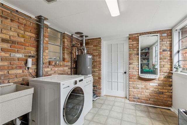 laundry room with washer / dryer, laundry area, brick wall, water heater, and a sink